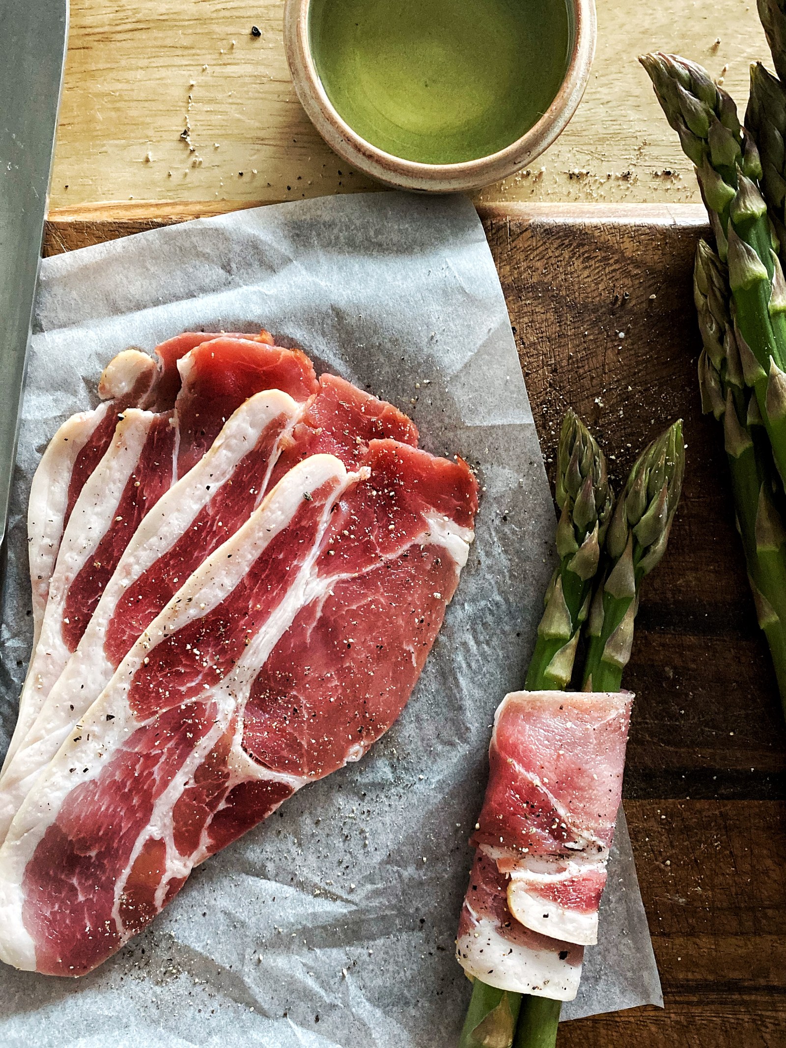 Beef steaks arranged on paper on a wooden board