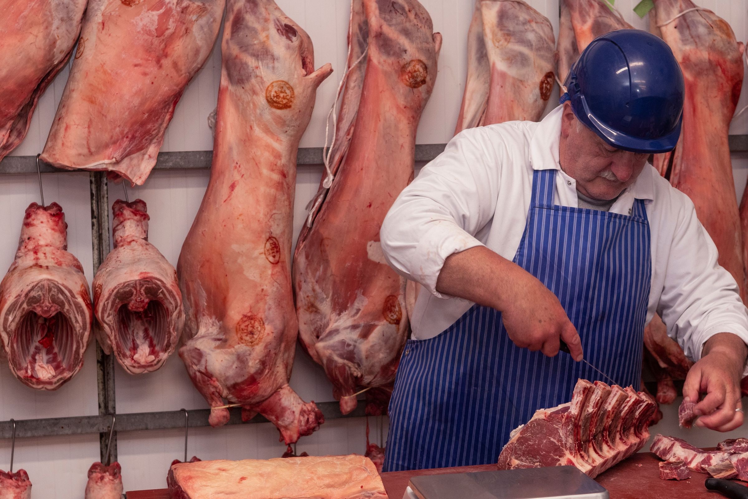 A Midland Foods butcher preparing beef at the cutting bench
